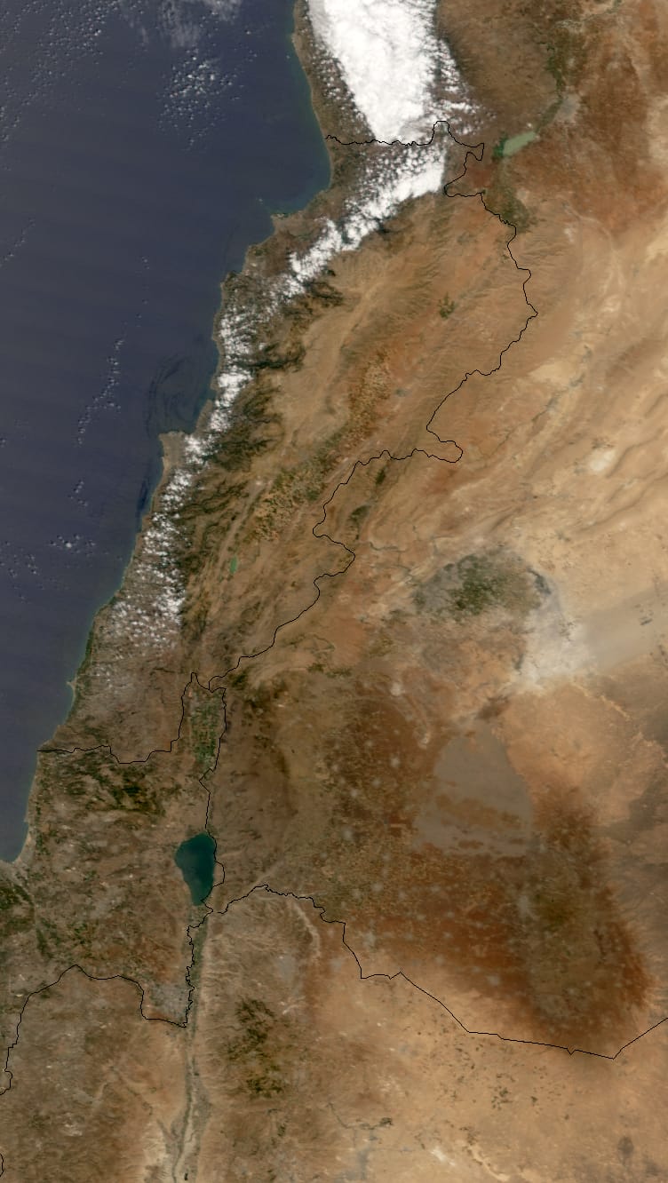 Oil Spill Along the Lebanese Coast
Among the casualties of the conflict between Lebanon and Israel in the summer of 2006 was the Mediterranean Sea. Damage to the Jiyyeh Power Station in Lebanon in mid-July released thousands of tons of oil along the Lebanese coast, perhaps rivaling the Exxon Valdez accident in 1989. By August 10, the spill covered approximately 120 kilometers (75 miles). The Moderate Resolution Imaging Spectroradiometer (MODIS) flying onboard NASA’s Terra satellite took this picture on August 15, 2006. The United Nations, the European Union, and the International Maritime Organization planned a meeting for August 17 to discuss cleanup operations, which had been delayed by the fighting between the neighboring countries.
This image shows Lebanon, its neighbor Syria, and the Mediterranean. Originating from the Jiyyeh Power Station, the oil slick spreads northward, well past the city of Beirut. The oil appears as a slightly darker shade of blue on the ocean water. Bright white clouds fringe the coastline, and the land area, though dotted with green, is largely brown and arid.