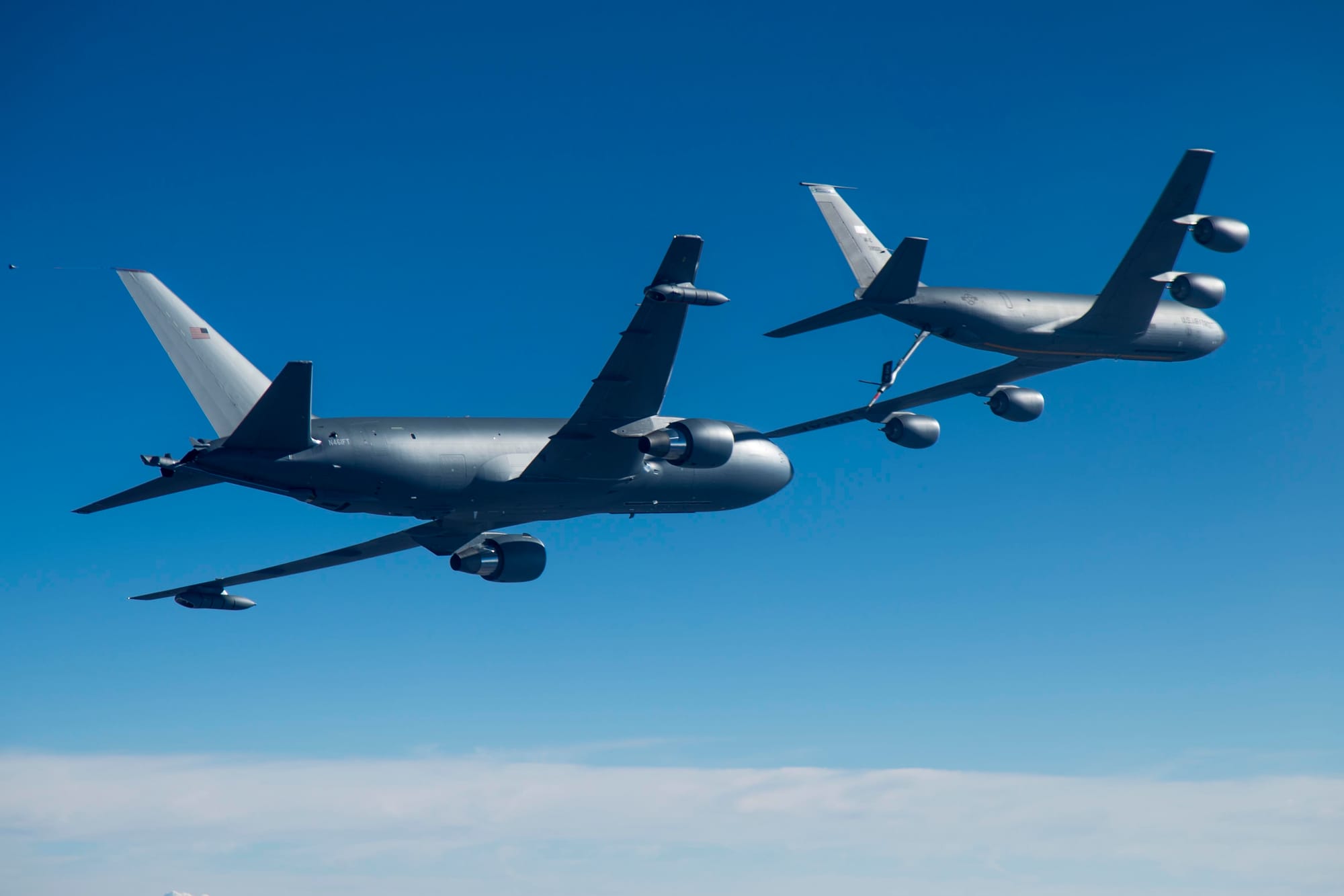 Photos of Boeing's KC-46A, left, conducting tests of aircraft acceleration and vibration exposure while flying  in receiver formation at various speeds and altitudes behind either the KC-10 Extender or the KC-135 Stratotanker. Testing for this phase was coordinated from Edwards Air Force Base, Calif., and conducted above Owens Valley and parts of the western Mojave Desert.
Unit: 92d Air Refueling Wing
