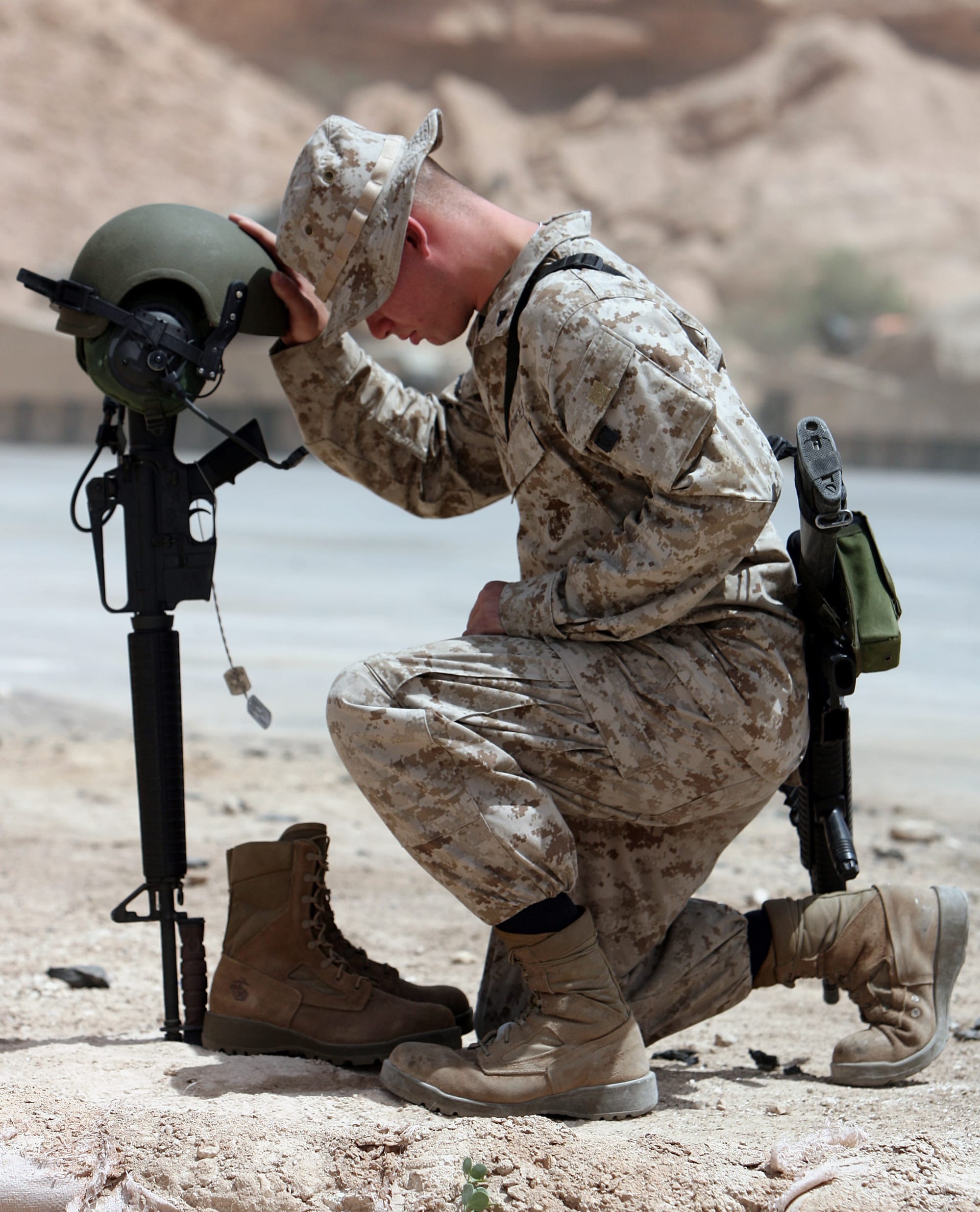 Cpl Alexander J. McCann, a 24-year-old from Methuen, Mass, pays his final respects to fellow tanker Lance Cpl. Michael L. Ford, who was killed April 26, 2006 in Iraq's western Al Anbar Province after the tank he was driving struck an improvised explosive device - a roadside bomb. Ford's unit - Twentynine Palms, Calif.-based Company C, 1st Tank Battalion - held a memorial service for the 19-year-old New Bedford, Mass., native April 30, 2006 at Al Asad, Iraq. Ford was part of Company C's third platoon, which operates with 1st Battalion, 7th Marine Regiment near the Iraqi-Syrian border. Ford's death was the first for the company of 120-plus Marines since the arrived in Iraq about six weeks ago. Company C will remain deployed to Iraq for at least another five months. "Commanders live their entire lives to have Marines like that under their command," said Capt. Jareed R. Duff, Company C's commanding officer, during the service.