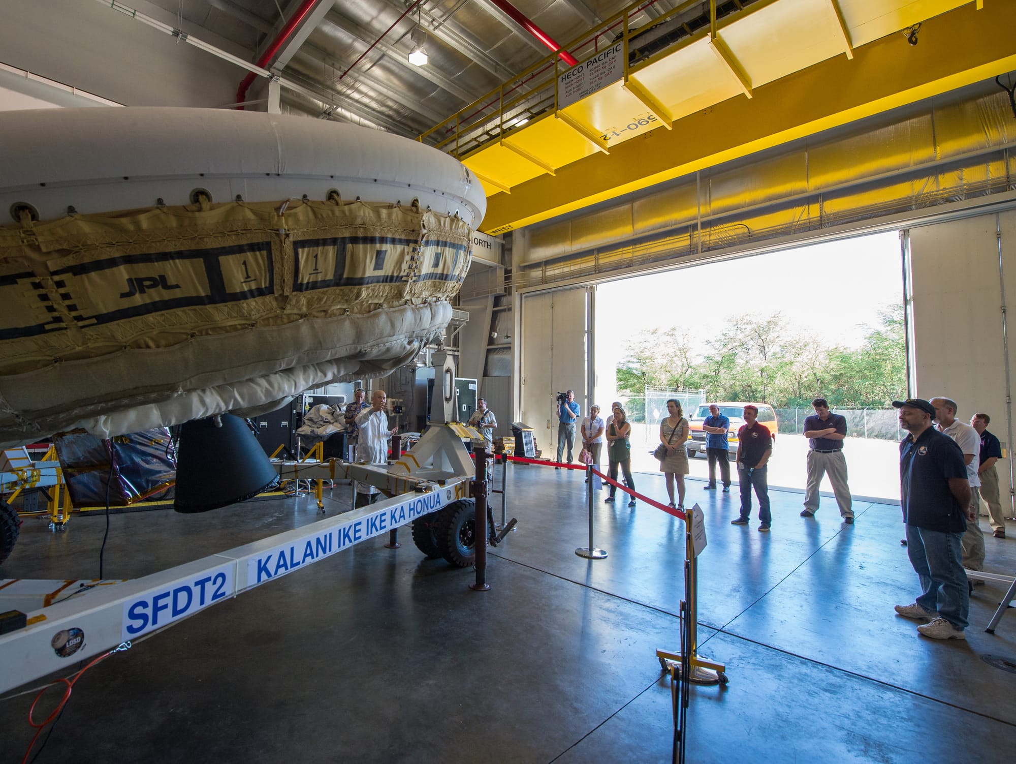 NASA's Jet Propulsion Laboratory (JPL) Low-Density Supersonic Decelerator (LDSD) Integration and Test Manager Ban Tieu talks with members of the media while standing next to the LDSD flight test vehicle, Monday, June 1, 2015, at the U.S. Navy Pacific Missile Range Facility (PMRF), Kauai, Hawaii.