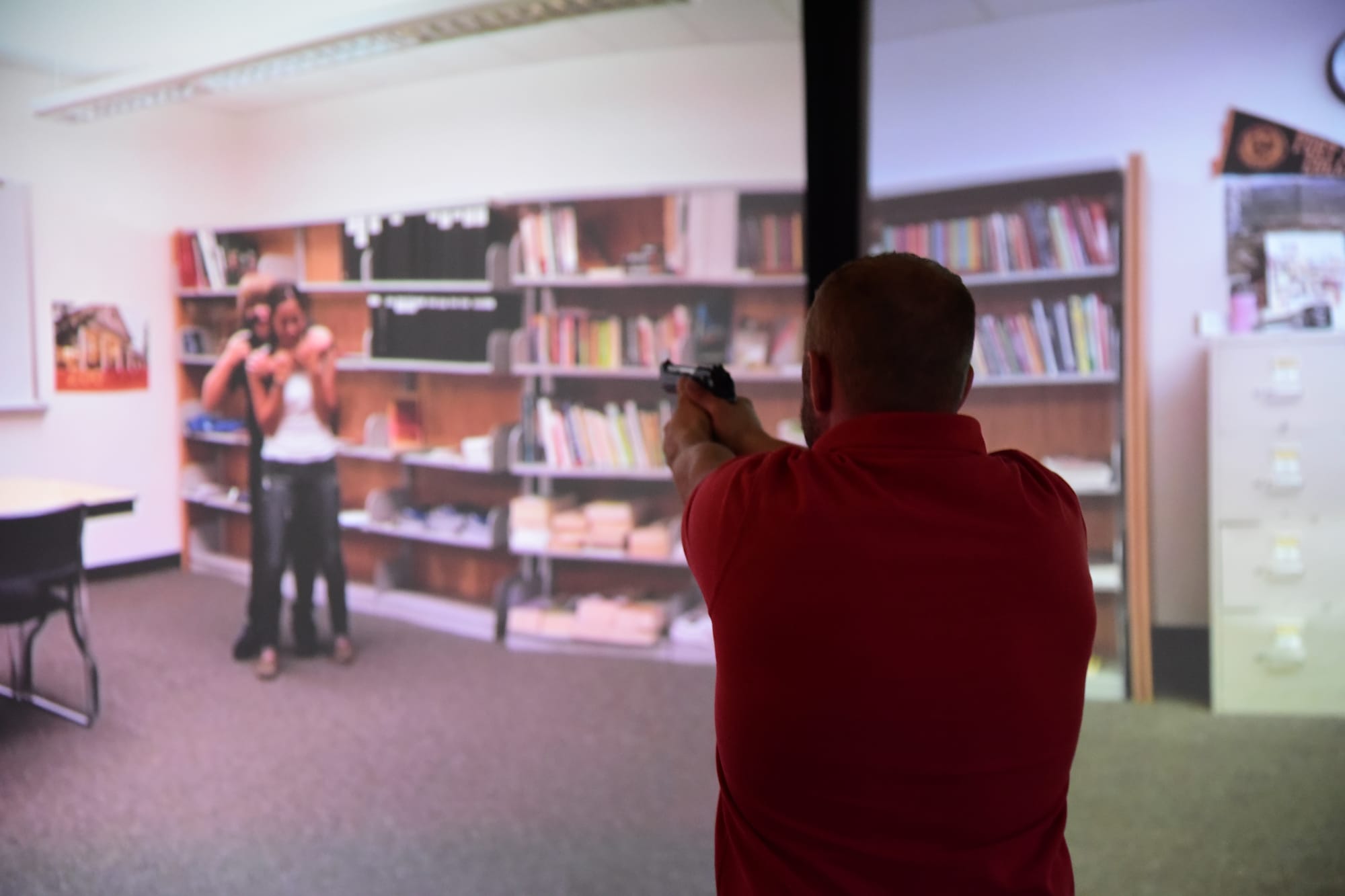 PETERSON AIR FORCE BASE, Colo. – An Air Force Office of Special Investigations special agent with the 8th Field Investigations Squadron works through a simulated hostage situation as part of a training day at the 21st Security Forces Training Complex at Peterson Air Force Base, Colo., June 10, 2016. Special agents teamed up with 21st Security Forces Squadron investigators and 21st Space Wing Public Affairs alert photographers to practice crime scene photography and handling active-shooter scenarios. (U.S. Air Force photo by Staff Sgt. Amber Grimm)