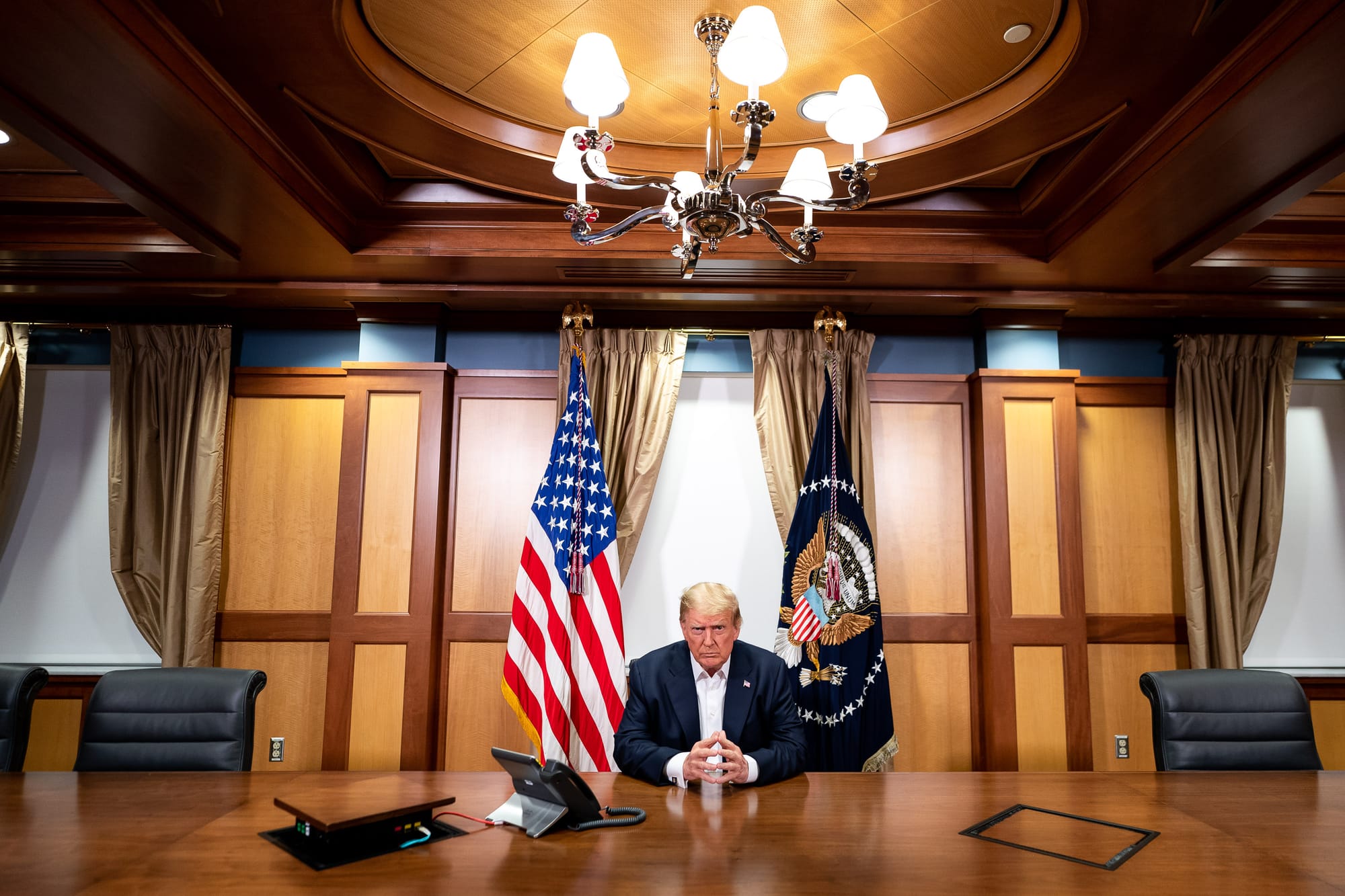 President Donald J. Trump, joined by Chief of Staff Mark Meadows, participates in a phone call with Vice President Mike Pence, Secretary of Defense Mark Esper, Secretary of State Mike Pompeo, Chairman of the Joint Chiefs of Staff Gen. Mark Milley and National Security Advisor Robert O’Brien Sunday, Oct. 4, 2020, in his conference room at Walter Reed National Military Medical Center in Bethesda, Md. (Official White House Photo by Tia Dufour)