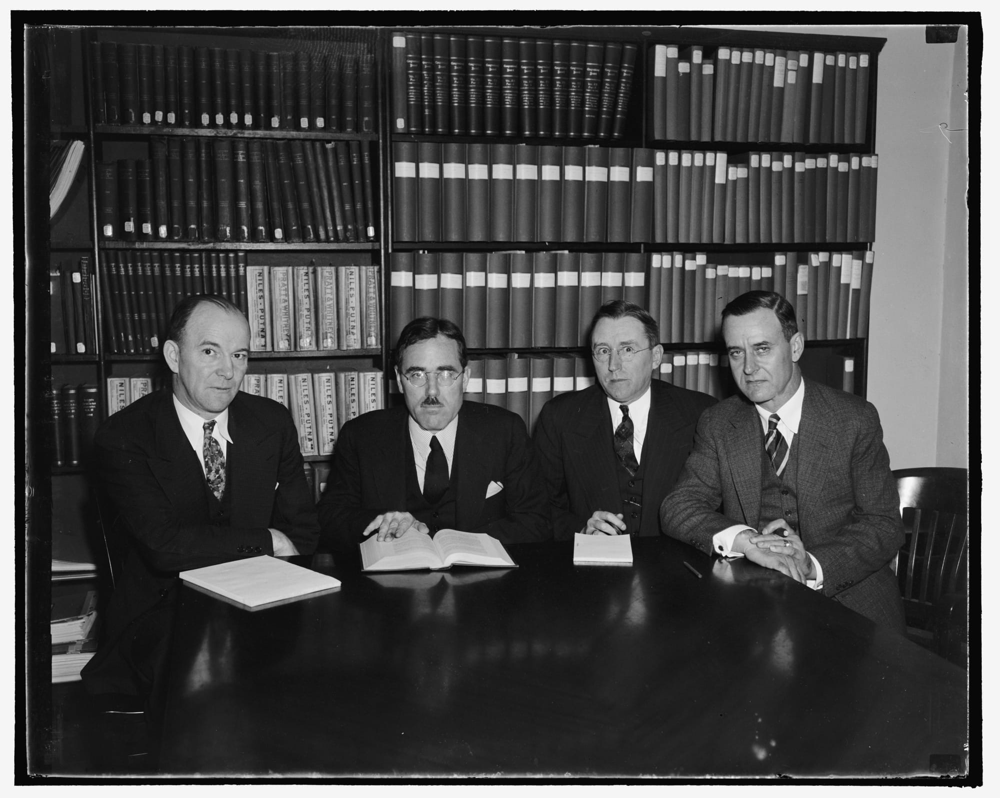 Title: Railroad Retirement Board is now constituted. Washington, D.C., Oct. 3. The Railroad Retirement Board at its meeting today welcomes M.R. Reed, new member of the board appointed by President Roosevelt, and James Gordon Robinson, newly chosen Head of the Railroad Unemployment Insurance Bureau. Mr. Reed will represent the carriers on the board while Mr. Robinson was chosen for the Directorship of Unemployment Insurance from the open competitive examination conducted by the United States Civil Service Commission, the first ever held for a ten thousand dollar a year administrative position. Pictured, left to right: James G. Robinson, Murray W. Latimer, Chairman; Lee M. Eddy. and M.R. Reed, 10/3/38
Abstract/medium: 1 negative&nbsp;: glass&nbsp;; 4 x 5 in. or smaller