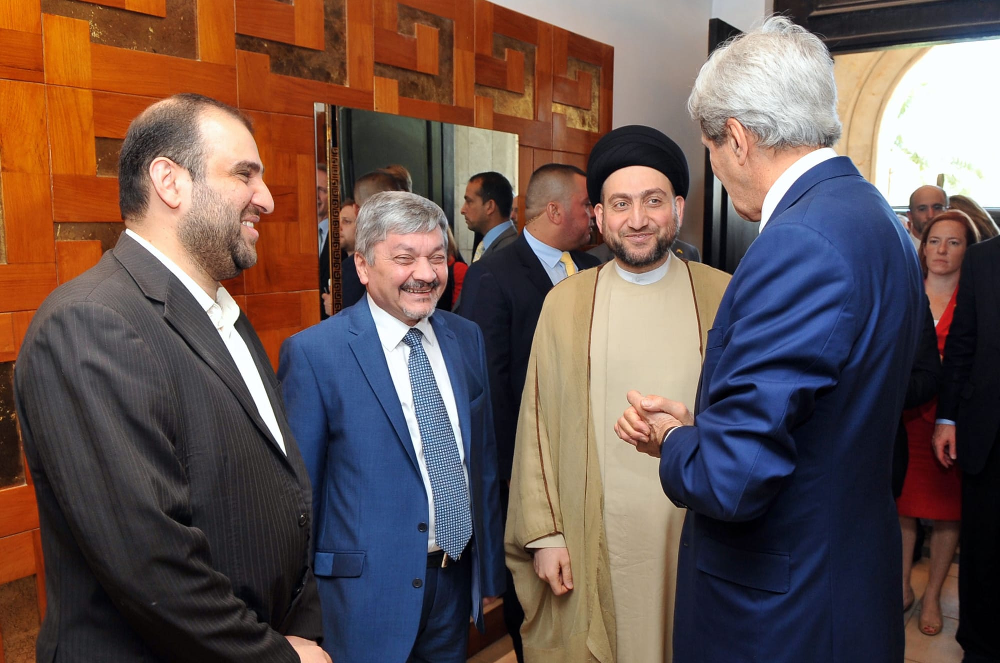 U.S. Secretary of State John Kerry chats with Islamic Supreme Council of Iraq Leader Ammar Hakim, his brother Mohnsin, left, and Council member Ibrahim Bahar al-Uloom, center, as he met in Baghdad with Prime Minister Nouri al-Maliki and other national leaders on June 23, 2014. [State Department photo/ Public Domain]