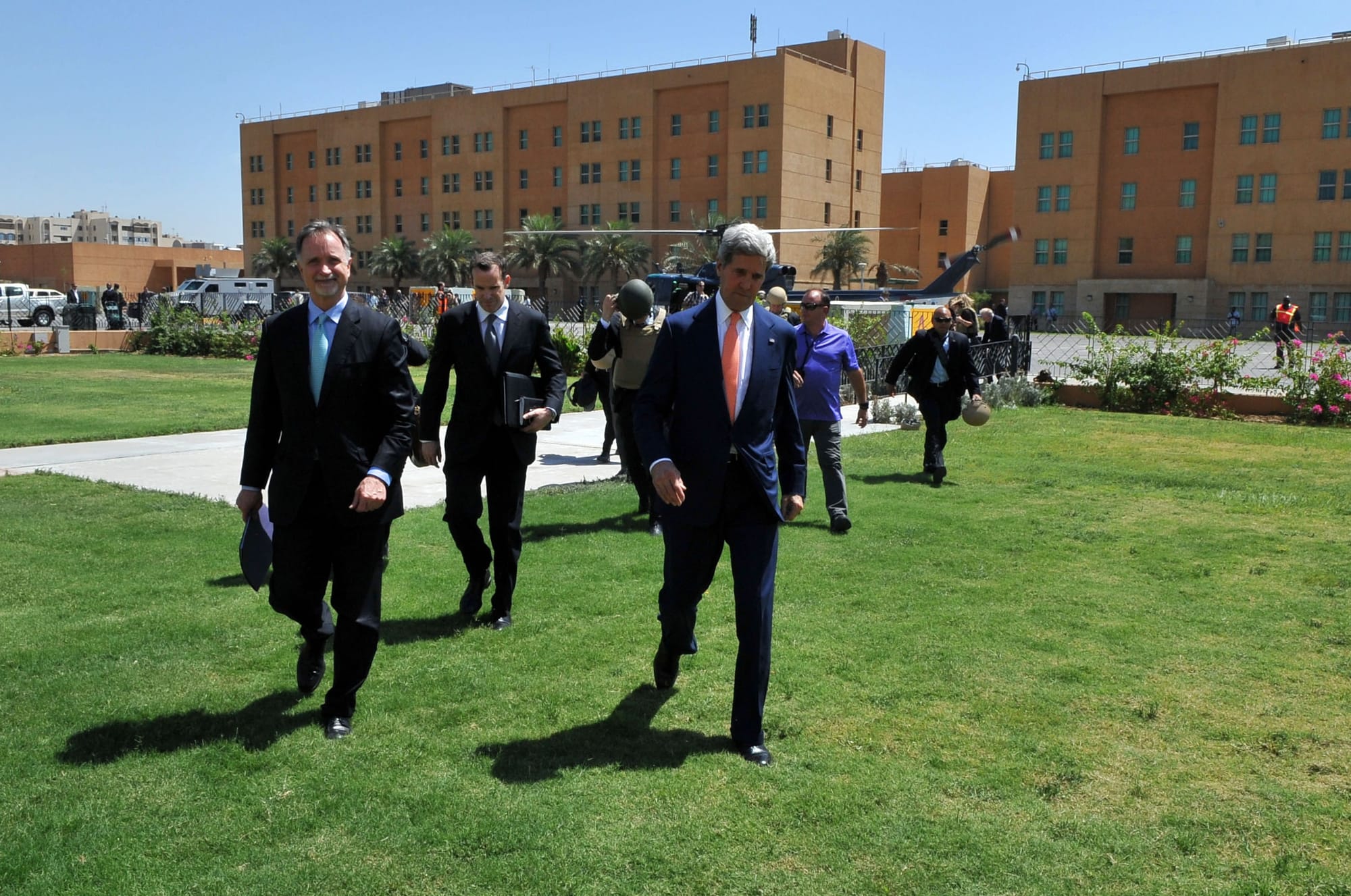 U.S. Secretary of State John Kerry, U.S. Ambassador to Iraq Steve Beecroft, and Deputy Assistant Secretary for Iraq and Iran Brett McGurk walk across the Embassy Baghdad compound after the Secretary arrived in the country for meetings with Iraqi Prime Minister Nouri al-Maliki and other top national leaders on June 23, 2014. [State Department photo/ Public Domain]