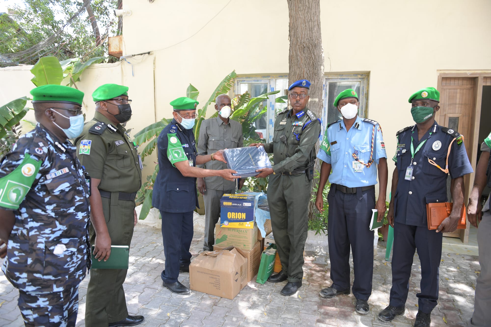 AMISOM Police Commissioner, Assistant Inspector General of Police (AIGP), Augustine Magnus Kailie, (Third from left) hands over office equipments donated by the African Union Mission in Somalia (AMISOM) to Deputy Police Commander of Banadir Region, General Mohammed Ismael, in Mogadishu, Somalia, on 6 April 2021. AMISOM Photo / Mokhtar Mohamed