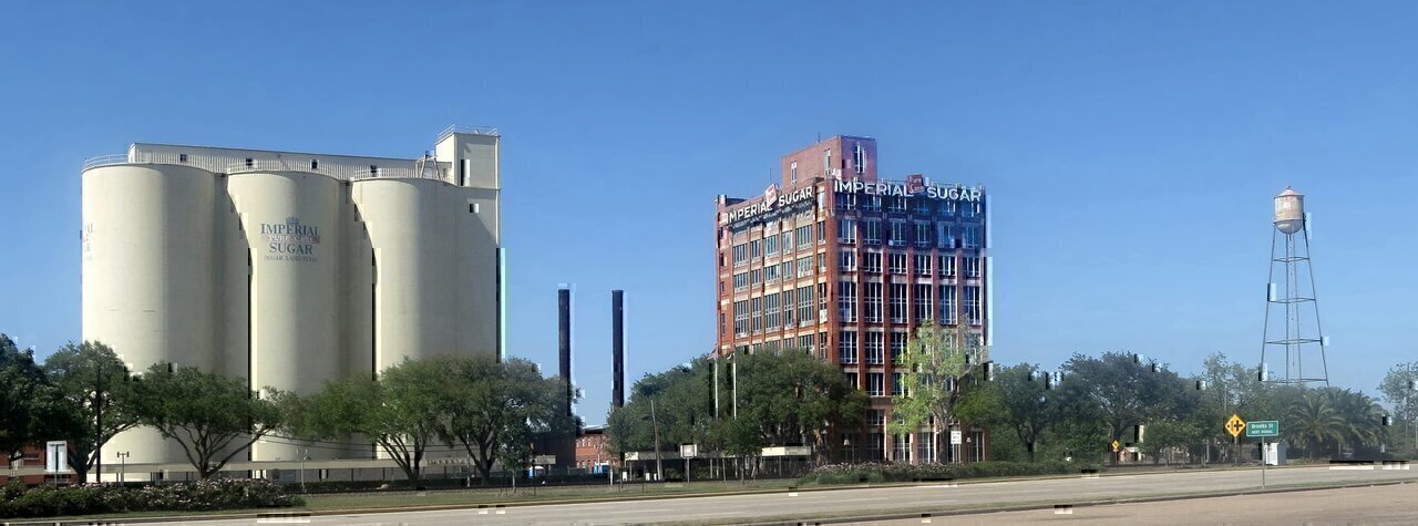 The Sugar Land Refinery.
Stephen F. Austin's colonists brought sugar cane to Fort Bend County in the 1820s. The Sugar Land area was once part of Oakland Plantation, where Nathaniel and Matthew Williams planted sugar cane about 1840. They began processing the cane in 1843 using a horse-powered mill and open-air cooking kettles. In 1853 the plantation and mill were purchased by William J. Kyle and Benjamin F. Terry. They improved the mill and promoted a railroad for the area, which they named Sugar Land. Terry later helped organize the famed Confederate cavalry unit, Terry's Texas Rangers, and was killed in the Civil War. After the war, the operation was sold to Edward H. Cunningham, who expanded the sugar mill into a refinery. W. T. Eldridge and Galveston businessman I. H. Kempner, Sr. bought the refinery in 1907. They began importing raw sugar to operate the refinery year-round because local cane was available only seasonally and in decreasing quantities in the early 1900s. Named by Kempner for the Imperial Hotel in New York City, the Imperial Sugar Company and the City of Sugar Land have grown steadily. During the 1970s, the Imperial Sugar Company produced more than three million pounds of refined cane sugar daily.