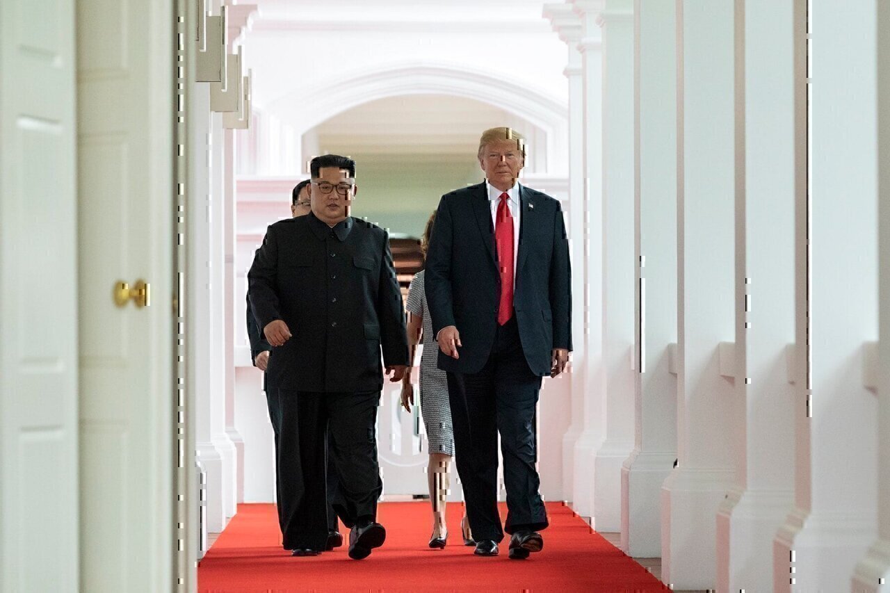 Donald Trump and Kim Jong-un walk together to their 1-on-1 meeting.