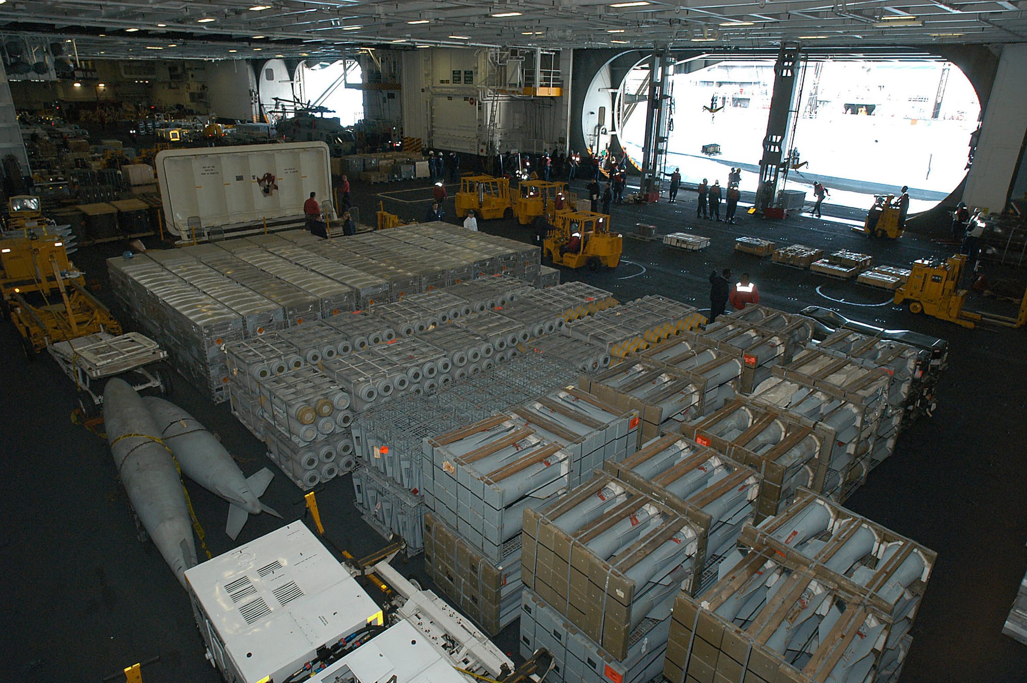Atlantic Ocean (Nov. 11, 2003) -- The hangar bay aboard the nuclear powered air craft carrier USS George Washington (CVN 73) is staged with weapons transferred from the Military Sealift Command ship USNS Supply (T-AOE 6).  The Norfolk, Va.-based carrier is conducting Composite Training Unit Exercise (COMPTUEX) in the Atlantic Ocean.  U S Navy photo by Photographer's Mate Airman Jessica Davis.  (RELEASED)