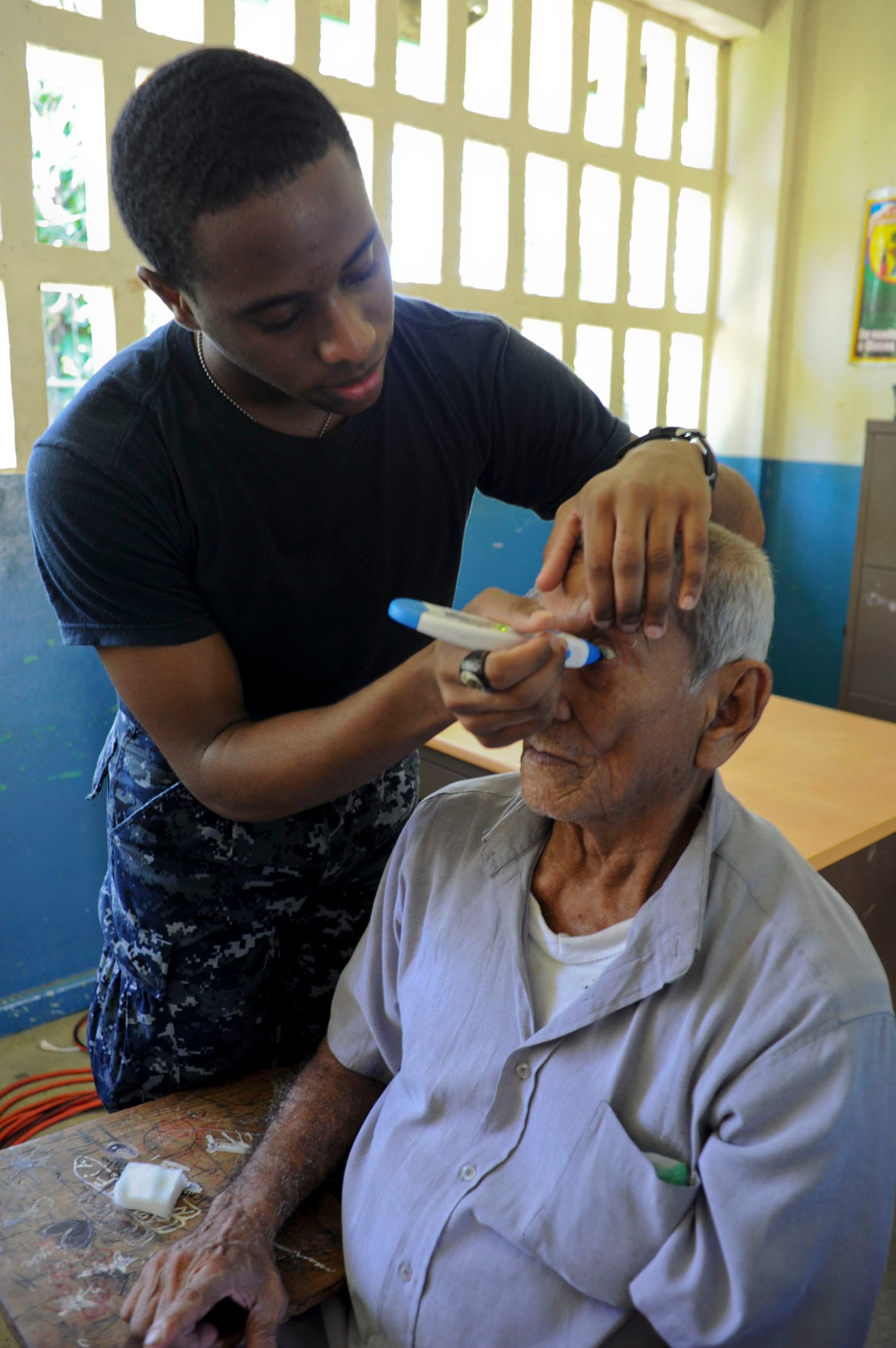 CHIRIQUE, Panama (Sept. 28,2010) Hospital Corpsman Aaron London, assigned to the multi-purpose amphibious assault ship USS Iwo Jima (LHD 7), checks a man's eye pressure during a medical screening at a medical site in Panama. Iwo Jima is off the coast of Panama supporting Continuing Promise 2010, a humanitarian and civic assistance mission. The assigned medical and engineering staff embarked aboard Iwo Jima are working with partner nation's teams to provide medical, dental, veterinary and engineering assistance to several different nations to improve mutual understanding of current medical issues and technology. (U.S. Navy photo by Mass Communication Specialist 1st Class Christopher B. Stoltz/Released)