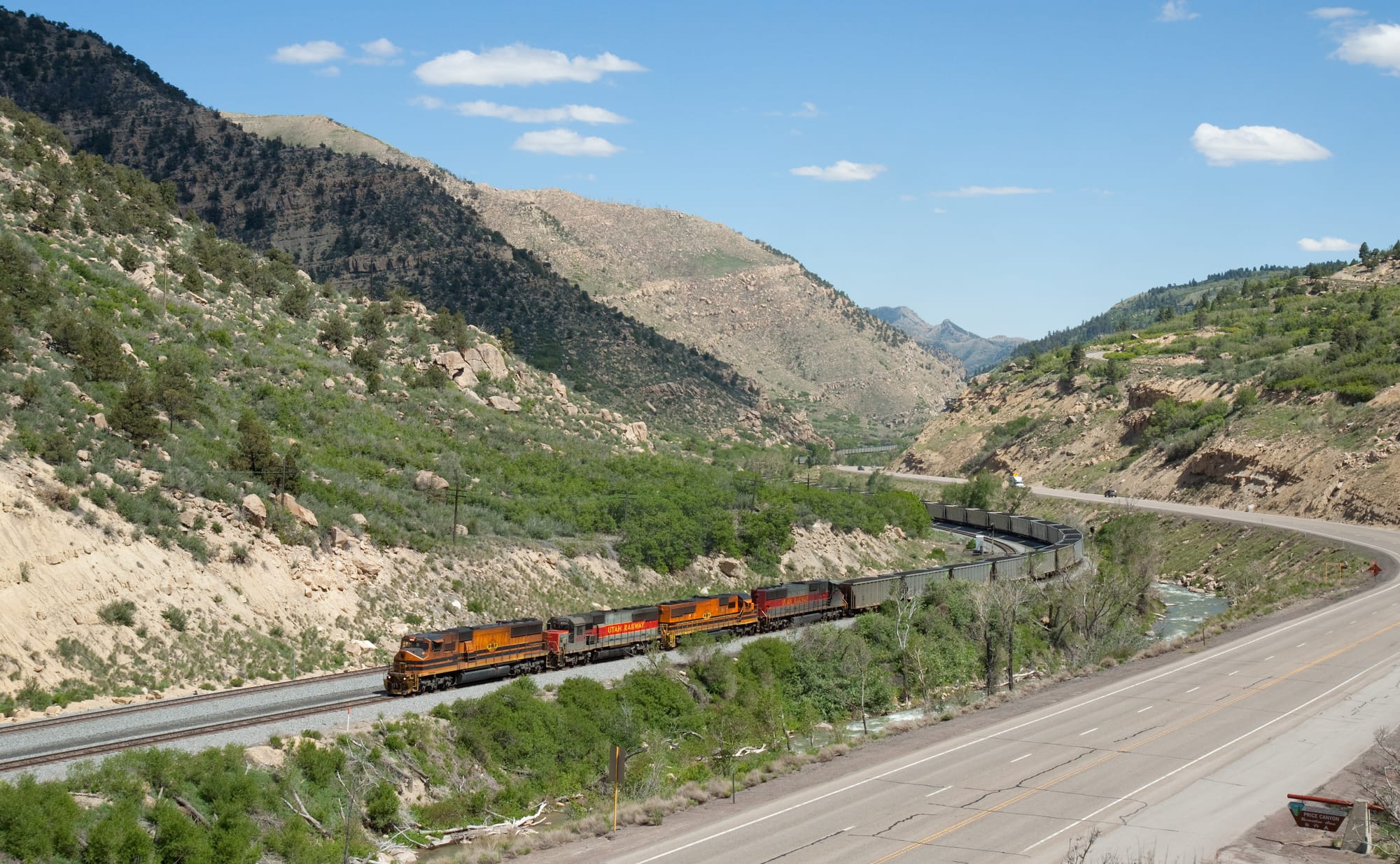 A deafening sound fills the valley, as a total of 10 (!) Utah Railway diesel engines climb the 24 per mil grade with a loaded 91 car coal train (somewhere around 9000 tons) at little over walking speed. The lead locomotive is an MK50-3. The picture was taken between Helper and Soldier Summit, Utah.