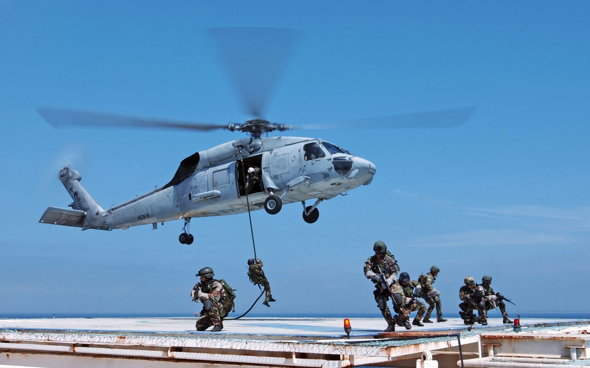 040331-N-3953L-604 Remote Training Facility (March 31, 2004) – Navy SEAL (SEa Air Land) operators practice on domestic Gas and Oil Platforms (GOPLAT) to prepare for future attacks on world oil production facilities..Navy SEALs are maritime special operations forces who strike from the SEa, Air and Land.  They operate in small numbers, infiltrating their objective areas by fixed-wing aircraft, helicopters, Navy surface ships, combatant craft and various underwater crafts.  SEALs have the ability to conduct a variety of high-risk missions- unconventional warfare, direct action, intelligence gathering, special reconnaissance, combat search and rescue, diversionary attacks and precision strikes- all in a clandestine fashion.  .Official U.S. Navy photo by Photographer's Mate 2nd Class Eric S. Logsdon, Naval Special Warfare Command Public Affairs Office.  (RELEASED LT Martin Clark, Assistant Public Affairs Officer Naval Special Warfare Command.)