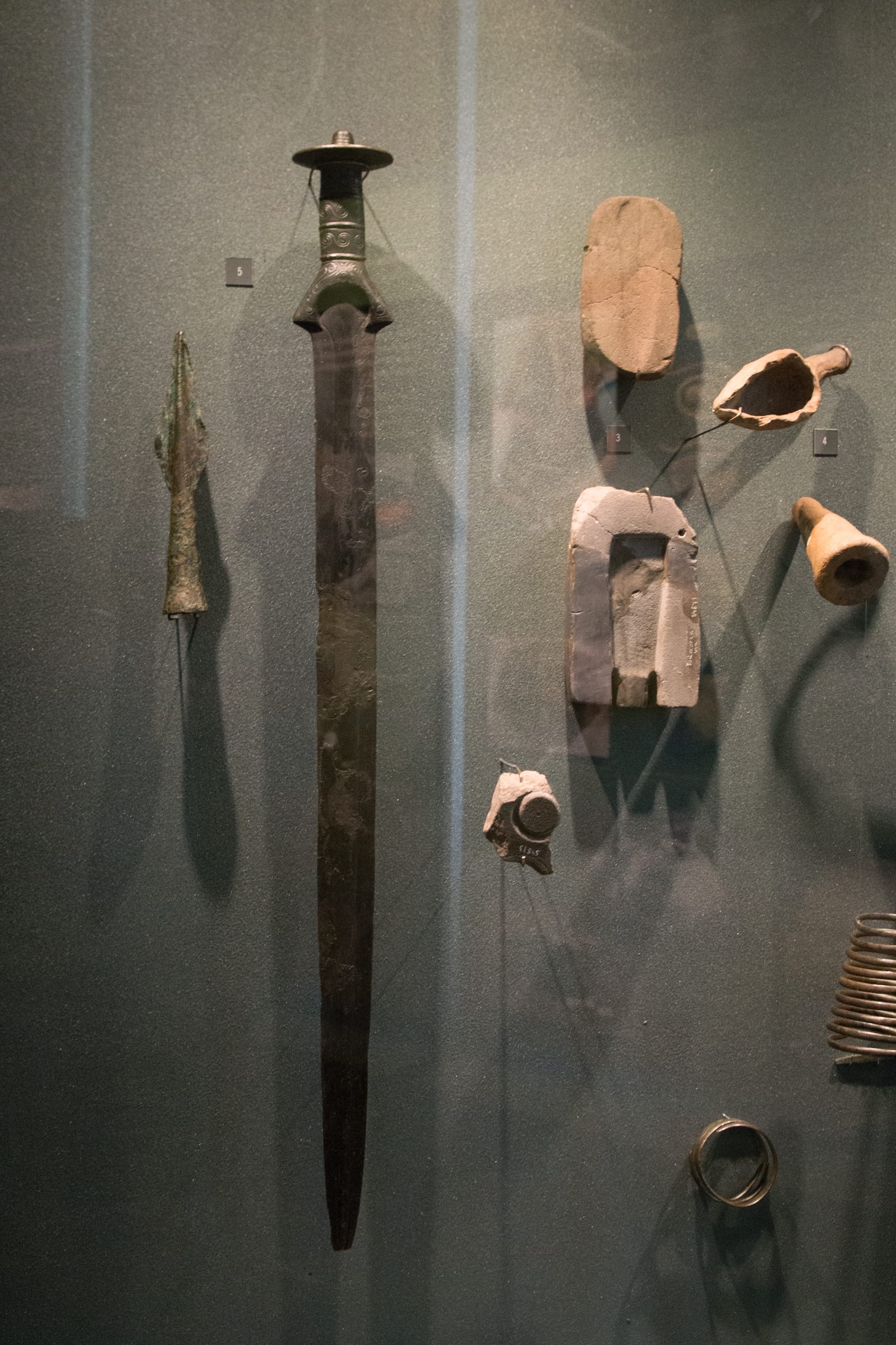 This Late Bronze Age sword was apparently cast into the Vltava river as a sacrificial offering beneath Vyšehrad Rock. The City of Prague Museum. Right: (3) Moulds for casting bronze objects. The City of Prague Museum.